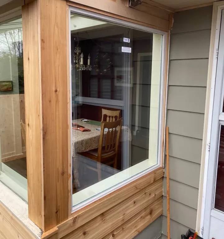 Newly installed bay window with natural wood paneling