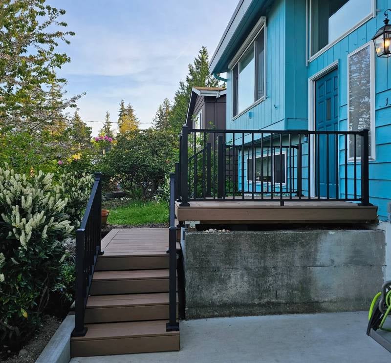 Blue house with white trim, seen from below looking up stairs
