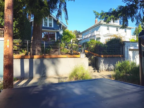 Residential driveway leading to a renovated home with landscaped front yard