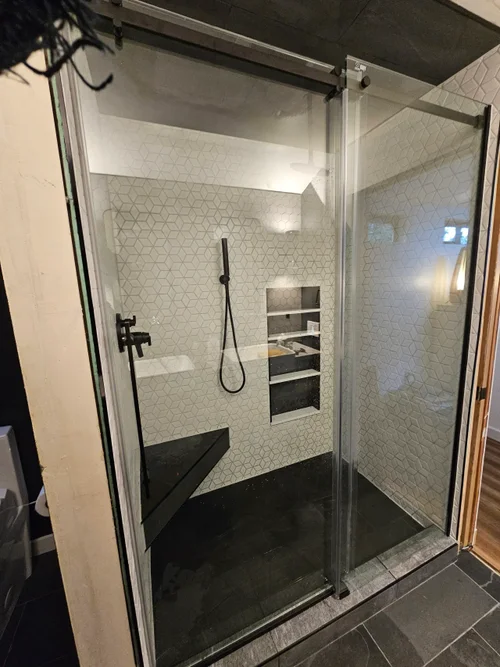 Frameless glass walk-in shower with modern tile surround