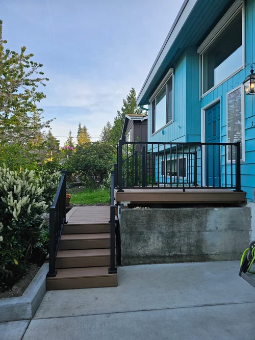 Front porch with composite decking and black aluminum railing